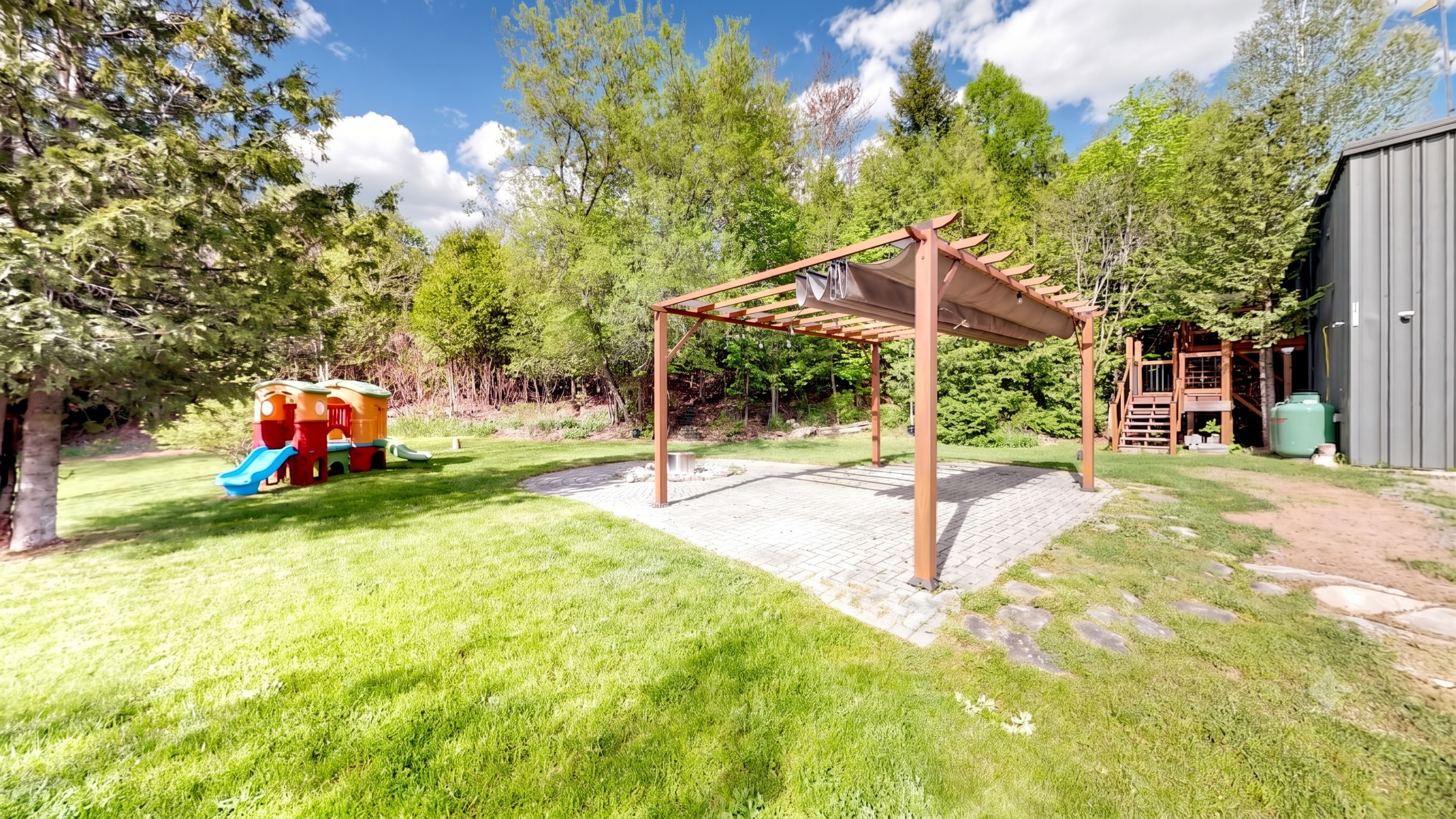 Open lawns and a pergola firepit beside the workshop at 44 Edgewood Road